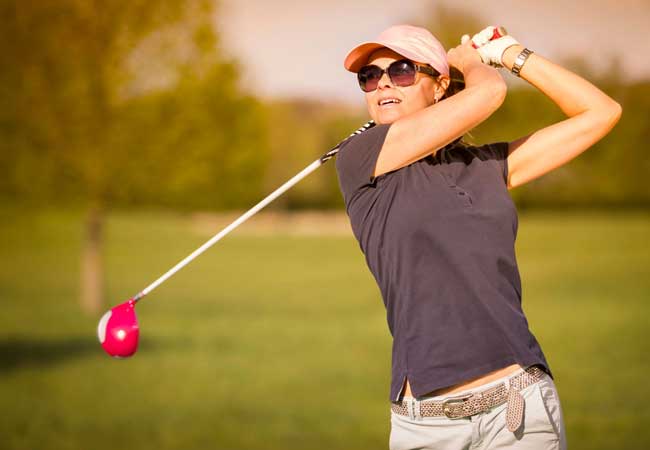 Lady golfer preparing for a shot on the course, representing Golf Clubs for Women and highlighting professional club fitting, equipment selection guidance, and performance-focused golf services tailored specifically for women players.